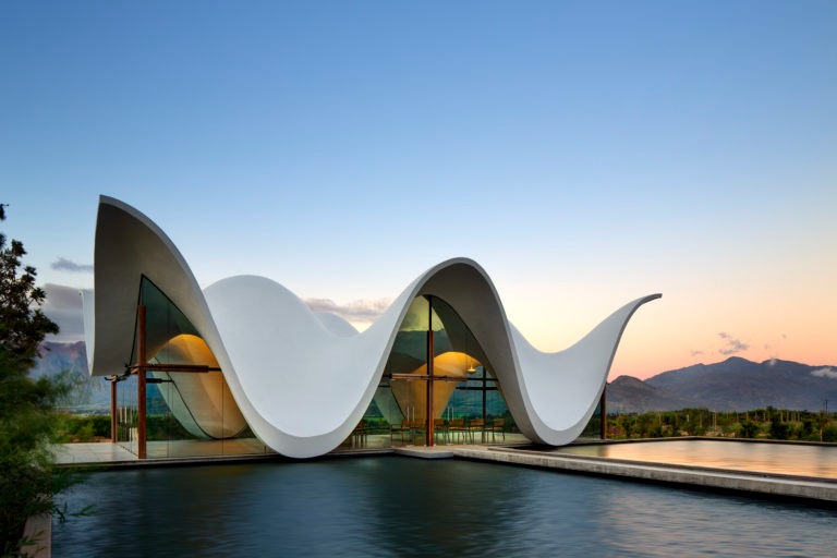 BOSJES Chapel in the Witzenberg Valley—an architectural marvel of undulating concrete forms that dialogue seamlessly with the surrounding landscape.