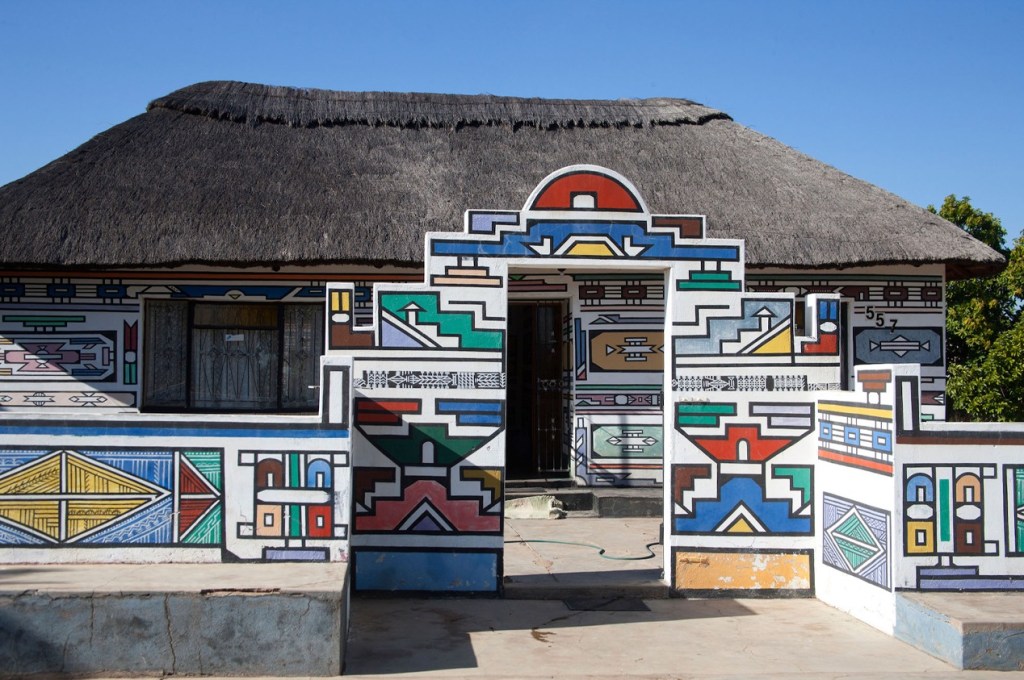 Ndebele geometric mural art in the tradition of Dr. Esther Mahlangu—a triumph of indigenous design, mathematical precision, and architectural heritage.